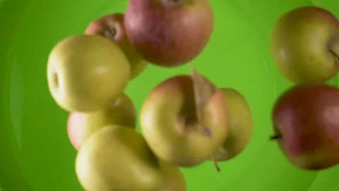 Slow motion apples fall into a container of water top view Stock Footage 85641692