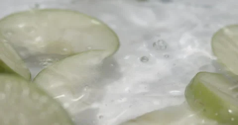 Slow Motion Apples Splashing into Water - Dynamic Fruit Footage Stock Footage 273532019