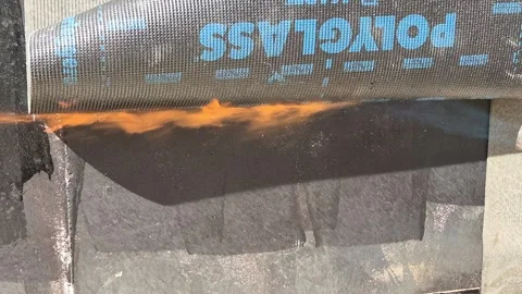 Slow Motion Applying Bituminous Waterproofing Membrane with Torch Stock-Footage 336498449