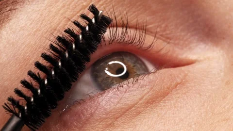 SLOW MOTION: Applying black mascara to the eyelashes with a makeup brush. A.. Stock Footage 263550162