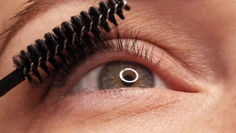 SLOW MOTION: Applying black mascara to the eyelashes with a makeup brush. A.. Stock Footage 307159161