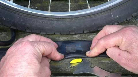 Slow motion - Applying patch adhesive to a bike inner tube puncture. Video stock 130385356