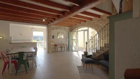 Slow motion arc Shot Rustic Open-Plan Interior Stone Arch Exposed Beams South Stock Footage 337533858