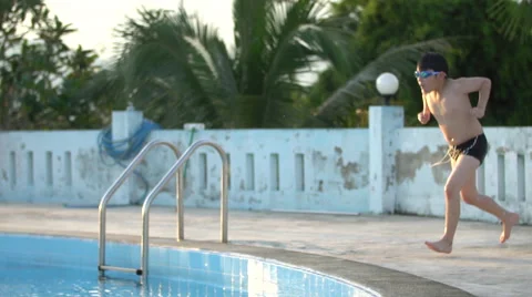 Slow motion of asian child playing in pool, Happy boy having fun on vacation. Stock Footage 68067612