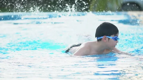 Slow motion of asian child playing in pool, Happy boy having fun on vacation. Stock Footage 68084745
