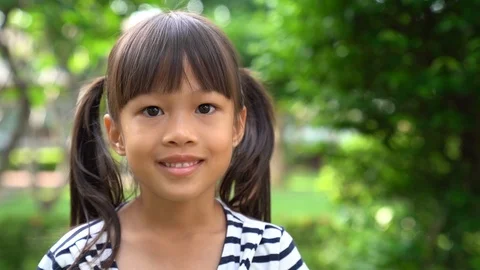 Slow motion of Asian girl smiling and la... | Stock Video | Pond5