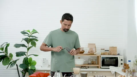 Slow motion, Asian man hand turning coffee bean grinder using coffee bean Stock Footage 241601604