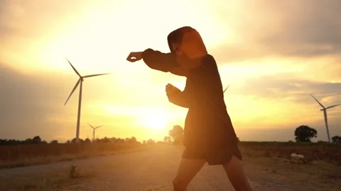 Slow motion Asian men training boxing against background sunset and windmill. Stock Footage 168016851