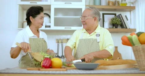 Slow motion of Asian Thai old couple or senior cook and doing salad in kitchen Stock Footage 136949059
