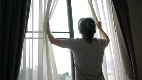 Slow motion of asian woman opening curtains. Stock Footage