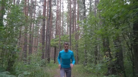 Slow motion athlete running in forest Stock Footage 117365848