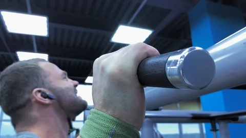 Slow motion.   An athletic strong man performing pull ups  in bar Training Stock Footage 117938028