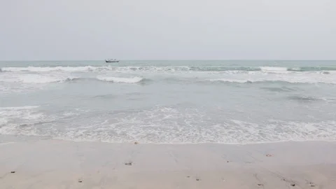 Slow motion Atlantic Ocean waves and fishing boat Kokrobite, Ghana Stock-Footage 274459486