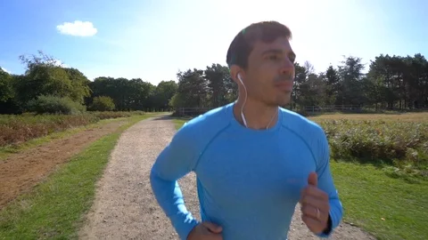 Slow Motion attractive man jogging, close up footage Stock Footage 96046116