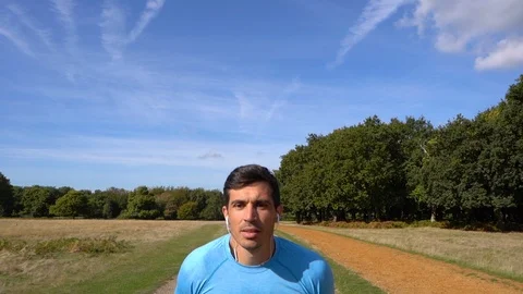 Slow Motion Attractive Man Jogging Towards Camera, close up face Stock Footage 96046439