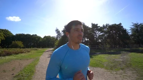 Slow Motion, Attractive Man Jogging Listening to Music Video stock 96046912
