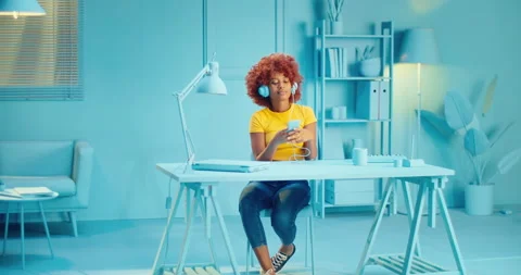 Slow motion of attractive pretty black woman with curly hair listening music on Stock Footage 164381593