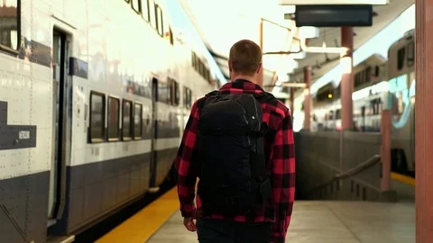 Slow motion: attractive young guy walking on train platform at Los Angeles train Stock Footage 108811376