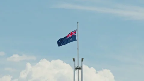 Slow Motion of Australian Flag at Half Mast Above Parliament House Stock Footage 301271320