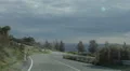 Slow motion of auto moving on bad serpentine road, driver pov through windscreen 4k or 4k+ Resolution