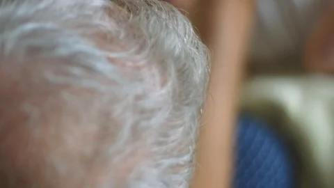Slow motion of baby looking at camera and holding grandfather's finger Stock Footage 114103523