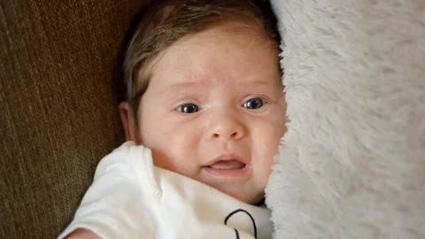 Slow motion of baby looking towards camera Stock Footage 107572285