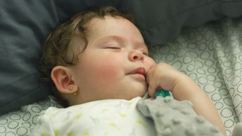 Slow motion of baby moving lips as she falls asleep Stock Footage 114645244