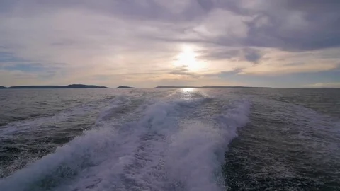 Slow motion of the back of a speedboat on the sunset Stock Footage 76730262