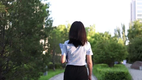 Slow motion of back view of female white-collar worker on the way to work Stock Footage 252736648