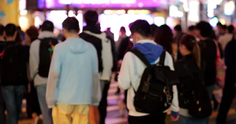 Slow motion back view of walking crowd at Causeway Bay crosswalk at night Stock Footage 309401979