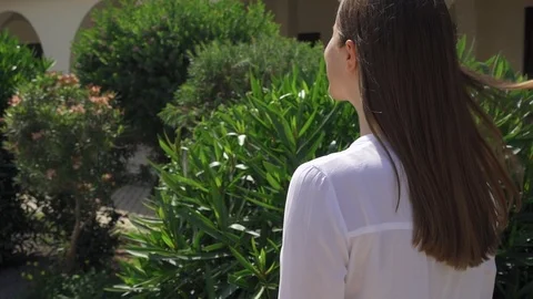 Slow Motion. Back view of young woman walk down street in european city. Female Stock Footage 109444109