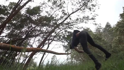 Slow Motion Backflip Full Twist Off of Tree Stock Footage 82353035