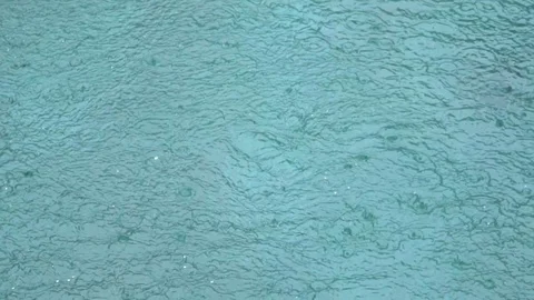 Slow motion: background of the rain and ripple on the water surface of the pool. Stock Footage 104334115