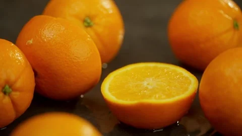 Slow motion background video of half an orange falling into water. Stock-Footage 277999251