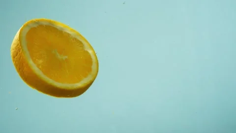 Slow motion background video of an orange falling into water. Stock Footage 262573757