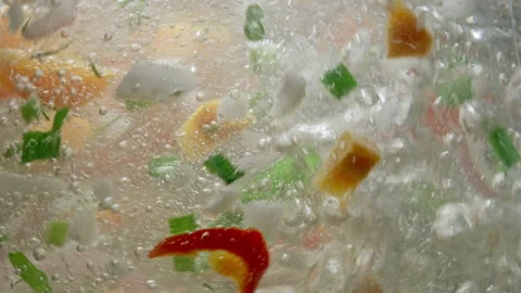 Slow motion background video of vegetables being cooked in hot water in the Vídeo Stock 227957650