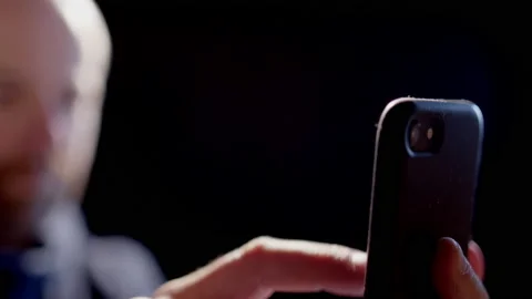 SLOW MOTION BACKLIT - An anonymous person using a smart phone Video stock 187121881