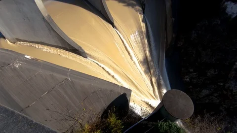 Slow motion backward moving tilt up water flows over spillway Stock Footage 120920826