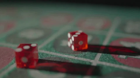 Slow motion backward tracking red dice with rack focus Stock Footage 335699982