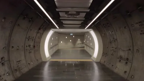 Slow motion backward walking motion at underground walking tunnel Stock Footage 158865259