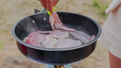 Slow Motion Bacon Placed Into Frying Pan During Outdoor Camping Cooking Stock Footage 336690399