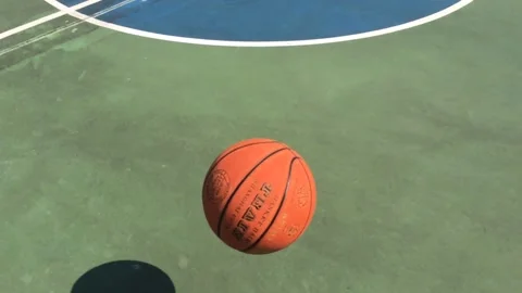Slow motion of a ball bouncing on a basketball court Stock Footage 144857251