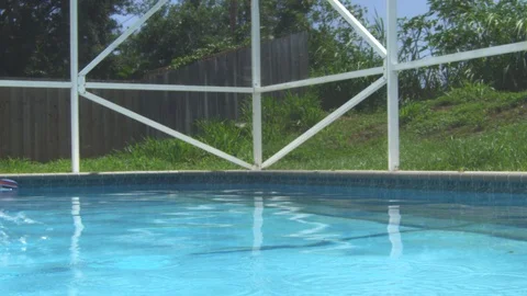 Slow motion of a ball floating by in a swimming pool Stock Footage 113938677