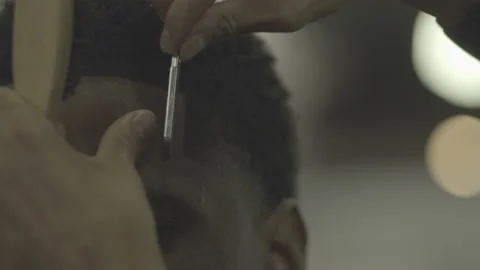 Slow motion barber using straight razor to edge up hair. S-Log ProRes 422 Stock Footage 236415863
