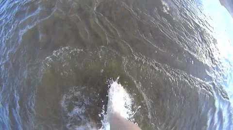 Slow motion of bare feet walking on the shore in water Stock Footage 51778280