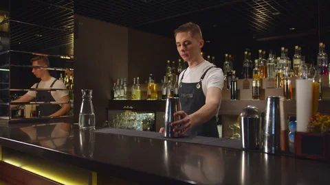 Slow motion, bartender plays with cocktail shakers at the bar Stock Footage 123663898
