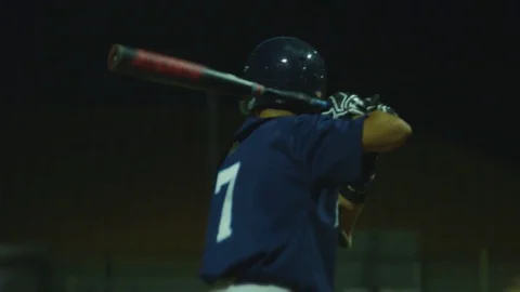 Slow motion of batter hitting ball, running to first base during baseball game Stock Footage