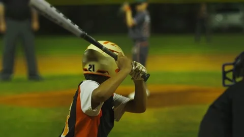 Slow motion of batter hitting ball and running to first base at baseball game Stock Footage 130280207