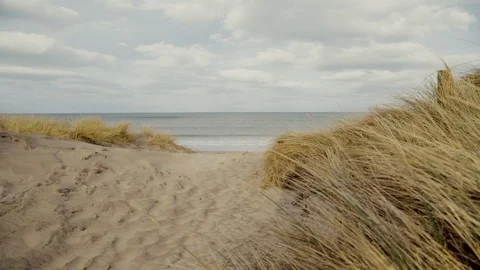 Slow motion Beach and sand dunes In Scotland With Waves Crashing In background Video stock 87660669