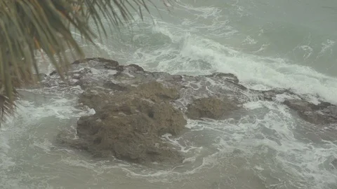 Slow Motion Beach Close Up Waves Crashing into Rocks Stock Footage 98897461